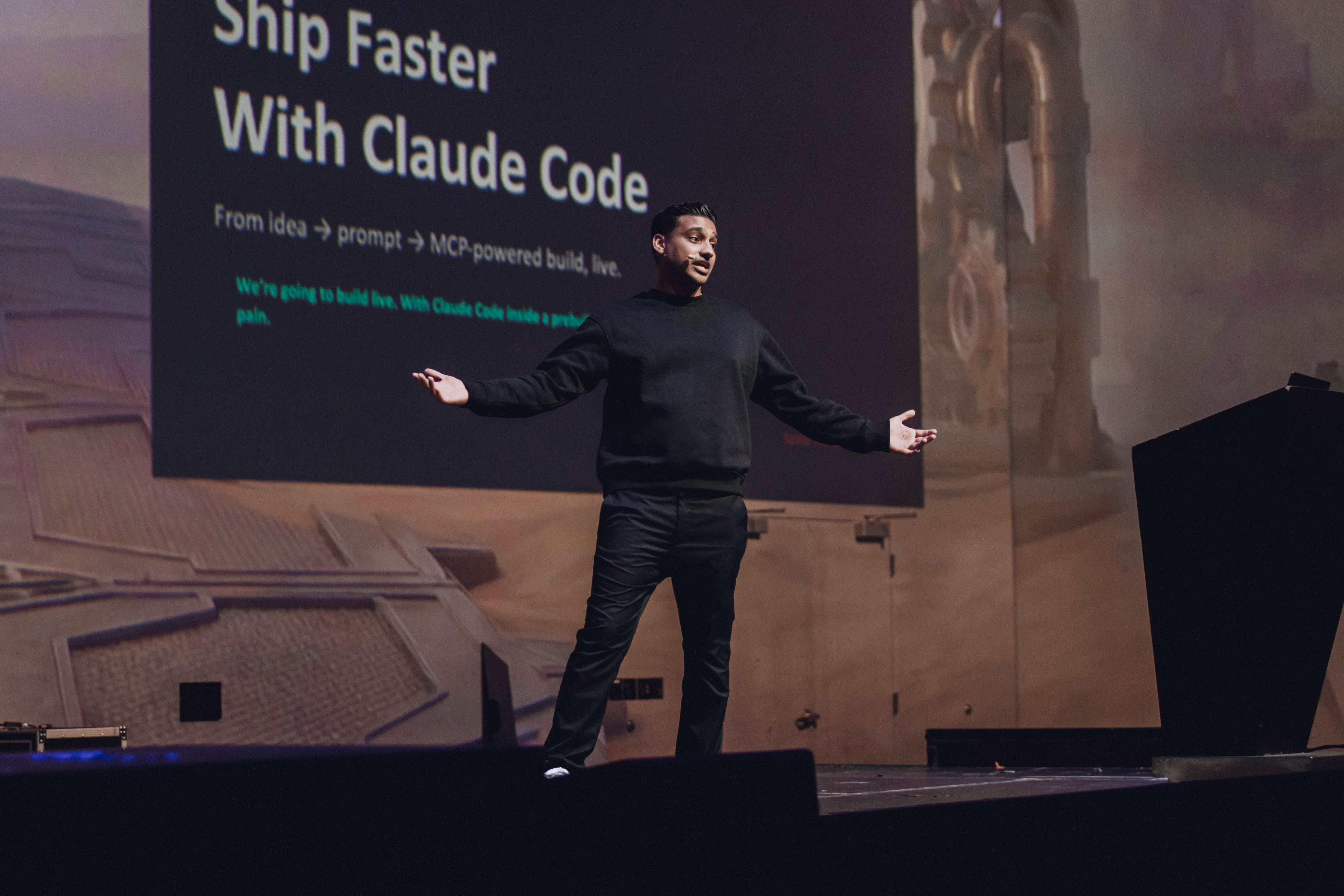 Samar Hussain speaking on stage at GeekOut Las Vegas